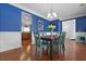 Bright dining room with hardwood flooring, modern lighting fixtures, with an open plan into the kitchen at 8566 Royal Palm Ln, North Charleston, SC 29420