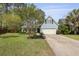 Two-story home with blue siding, attached garage, and lush green lawn creates a picturesque curb appeal at 8566 Royal Palm Ln, North Charleston, SC 29420