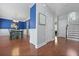 Open hallway with hardwood floors, connecting dining area, stairs and other rooms at 8566 Royal Palm Ln, North Charleston, SC 29420