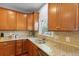 Kitchen features granite countertops, stainless steel sink, and wood cabinets with ample storage at 8566 Royal Palm Ln, North Charleston, SC 29420