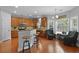 Eat-in kitchen features wood cabinets, granite counters, stainless steel appliances, and a seating area at 8566 Royal Palm Ln, North Charleston, SC 29420