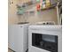 This laundry room features a washer and dryer, complemented by wire shelving for organized storage at 8566 Royal Palm Ln, North Charleston, SC 29420