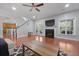 Bright living room features a fireplace, staircase, hardwood floors, french doors, and large windows at 8566 Royal Palm Ln, North Charleston, SC 29420