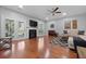 Spacious living room with hardwood floors, fireplace, and natural light creates a cozy atmosphere at 8566 Royal Palm Ln, North Charleston, SC 29420