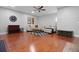 Spacious living room with hardwood floors, ceiling fan, and large sectional sofa with a coffee table at 8566 Royal Palm Ln, North Charleston, SC 29420