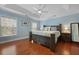 Spacious main bedroom offers tray ceilings, a ceiling fan, and windows for ample natural light at 8566 Royal Palm Ln, North Charleston, SC 29420