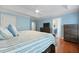 Bright main bedroom boasts hardwood floors, a tray ceiling, and stylish furniture at 8566 Royal Palm Ln, North Charleston, SC 29420