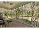 Relax on this screened porch, complete with comfortable seating, ceiling fan and view of the serene yard at 8566 Royal Palm Ln, North Charleston, SC 29420