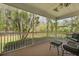 Relax on this screened porch, complete with comfortable seating, and ceiling fan with great view of the yard at 8566 Royal Palm Ln, North Charleston, SC 29420