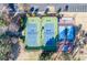 An aerial view featuring tennis, shuffleboard, and basketball courts with lush landscaping at 8642 W Fairway Woods Dr, North Charleston, SC 29420
