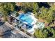An aerial view of the community pool area featuring the pool, playground, clubhouse, and parking at 8642 W Fairway Woods Dr, North Charleston, SC 29420