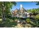 Spacious backyard featuring lush landscaping, a patio area, and mature trees at 8642 W Fairway Woods Dr, North Charleston, SC 29420