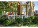 Landscaped backyard featuring lush greenery, mature trees, and outdoor living space at 8642 W Fairway Woods Dr, North Charleston, SC 29420