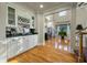 Well-lit bar area with cabinets, wine storage, and a view of the living room and kitchen at 8642 W Fairway Woods Dr, North Charleston, SC 29420