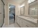Bathroom featuring double sinks, granite countertops, and access to the bedroom at 8642 W Fairway Woods Dr, North Charleston, SC 29420