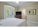 Comfortable bedroom with neutral walls and french doors leading to a balcony at 8642 W Fairway Woods Dr, North Charleston, SC 29420