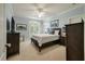 Comfortable bedroom with neutral color palette, carpeted floor, french doors and classic furnishings at 8642 W Fairway Woods Dr, North Charleston, SC 29420