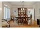 Elegant dining room with hardwood floors, a china cabinet, and a view of the kitchen at 8642 W Fairway Woods Dr, North Charleston, SC 29420