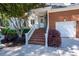 Welcoming home entrance with brick steps, white railings, and well-maintained landscaping at 8642 W Fairway Woods Dr, North Charleston, SC 29420