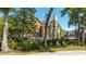 Beautiful home exterior with a well-maintained lawn, mature trees, and charming architectural details at 8642 W Fairway Woods Dr, North Charleston, SC 29420