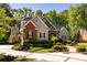 Charming home with a well-manicured lawn, mature trees, and a circular driveway at 8642 W Fairway Woods Dr, North Charleston, SC 29420