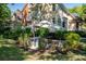 Stunning home exterior with lush landscaping, a charming patio, and elegant architectural details at 8642 W Fairway Woods Dr, North Charleston, SC 29420