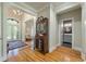 Spacious foyer featuring hardwood floors, an antique desk, and a glimpse of the powder room at 8642 W Fairway Woods Dr, North Charleston, SC 29420