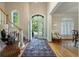 Welcoming foyer with hardwood floors, a decorative rug, and a view of the front entrance at 8642 W Fairway Woods Dr, North Charleston, SC 29420