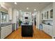 Open-concept kitchen with a large island, stainless steel appliances, and a view of the living room at 8642 W Fairway Woods Dr, North Charleston, SC 29420