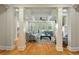 Elegant living room featuring hardwood floors, coffered ceilings, fireplace, and large windows offering natural light at 8642 W Fairway Woods Dr, North Charleston, SC 29420