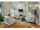 Elegant living room with tall ceilings, a cozy fireplace, and a staircase at 8642 W Fairway Woods Dr, North Charleston, SC 29420