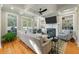Bright living room featuring a fireplace, coffered ceilings, and backyard views through large windows at 8642 W Fairway Woods Dr, North Charleston, SC 29420