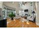 Bright living room with a soaring ceiling, fireplace, and large windows at 8642 W Fairway Woods Dr, North Charleston, SC 29420