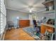 Inviting office features hardwood floors, built-in shelves, and a desk with a leather chair at 8642 W Fairway Woods Dr, North Charleston, SC 29420
