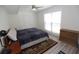 Comfortable bedroom with a large window, ceiling fan, closet, and stylish wooden floor at 870 Colony Dr # A6, Charleston, SC 29407