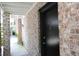 Townhouse doorway with a black door and number '6' on a brick exterior, inviting and well-maintained at 870 Colony Dr # A6, Charleston, SC 29407