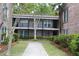 Charming townhouse exterior with well-kept landscaping, a walkway, and inviting entrances to the units at 870 Colony Dr # A6, Charleston, SC 29407