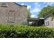 Brick exterior with a covered walkway and green landscaping around the building and sign at 870 Colony Dr # A6, Charleston, SC 29407