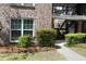 Close-up of a townhouse exterior featuring a window, stairs, landscaping, and a well-maintained pathway at 870 Colony Dr # A6, Charleston, SC 29407