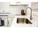 Beautiful kitchen showcasing white cabinets, a stainless steel sink, and granite countertops at 870 Colony Dr # A6, Charleston, SC 29407