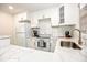 Bright kitchen with white cabinets, countertops, subway tile backsplash, and stainless steel appliances at 870 Colony Dr # A6, Charleston, SC 29407