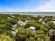Picturesque aerial view of a coastal community with a beautiful beach and lush landscape at 9 24Th Ave, Isle of Palms, SC 29451