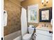 Full bathroom featuring a shower-tub combo, neutral tile surround, and a classic mirror and vanity at 9 24Th Ave, Isle of Palms, SC 29451