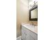 Bathroom featuring a white vanity with marble countertop, brushed nickel faucet, and decorative framed mirror at 9 24Th Ave, Isle of Palms, SC 29451