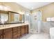 Bright bathroom featuring double sinks, a glass shower, plenty of counter space, and a large mirror at 9 24Th Ave, Isle of Palms, SC 29451
