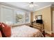 Well-lit bedroom with ceiling fan, dresser with TV, plush patterned bedding, and a warm, inviting atmosphere at 9 24Th Ave, Isle of Palms, SC 29451