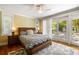 A serene bedroom features a comfortable bed, a neutral rug, hardwood floors, and sliding glass doors at 9 24Th Ave, Isle of Palms, SC 29451