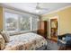Sunlit bedroom featuring seashell-themed bedding, an adjacent bathroom, and a vintage wood wardrobe for storage at 9 24Th Ave, Isle of Palms, SC 29451