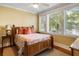 Comfortable bedroom with three windows, decorative pillows, side tables, and wood accents that add warmth at 9 24Th Ave, Isle of Palms, SC 29451