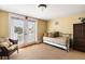 Bright bedroom featuring a daybed, wicker chair, and French doors leading to a balcony at 9 24Th Ave, Isle of Palms, SC 29451
